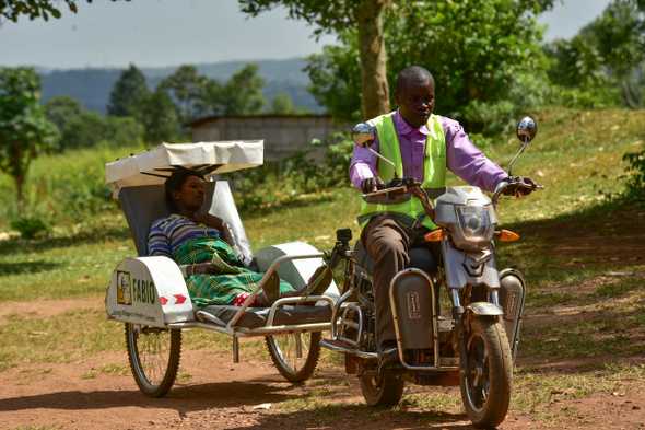 Where the terrain is hilly, the ambulances use rechargeable electric cycles. Pregnant women like Sandra Naigaga, who used to walk kilometres for care can now use the service.  [Nicholas Bamulanzeki/Al Jazeera]